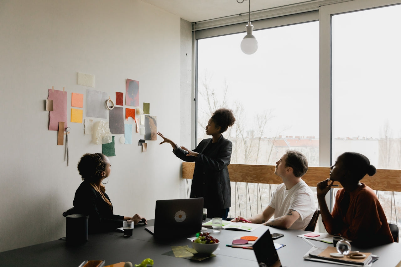 Team workshop around a table, representing ecommerce strategy and customer journey planning