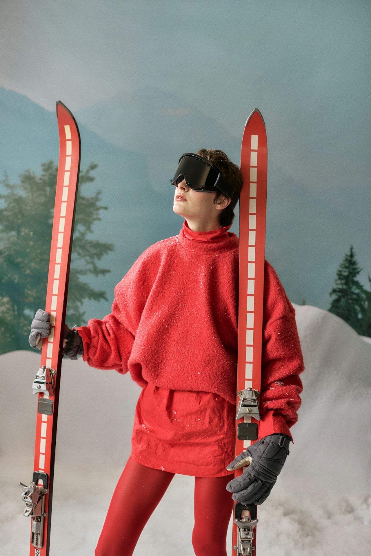 Person holding skis in a studio scene, representing premium high-AOV categories