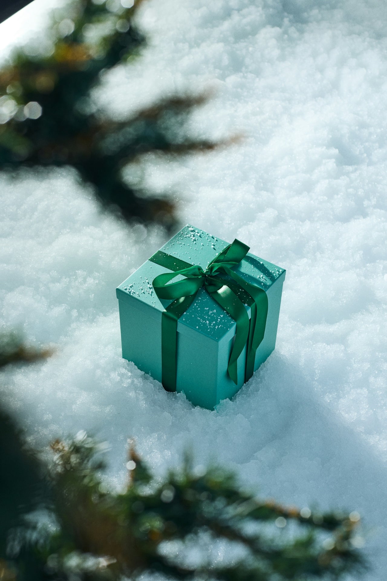 Gift box in snow with ribbon, representing post-purchase experience and retention